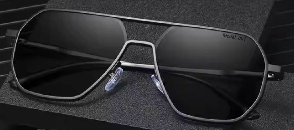 Phos bold black photochromic sunglasses, folded and placed on a dark, stylish background.
